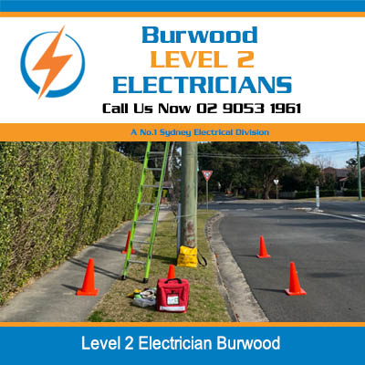 Level 2 electrician electrical worksite with safety cones and equipment set up on residential street in Burwood